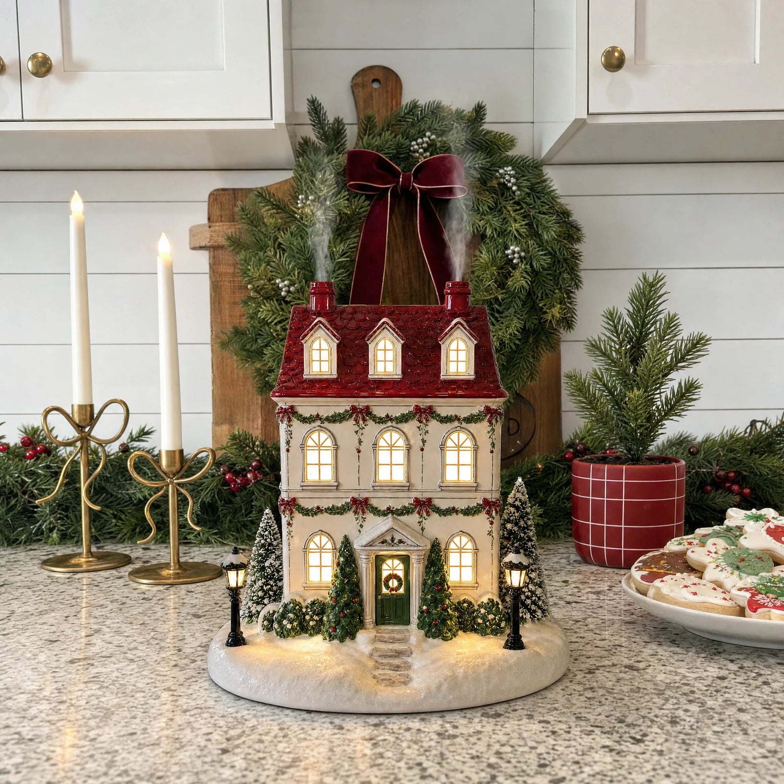 Holiday house diffuser with a red roof in a festive home setting